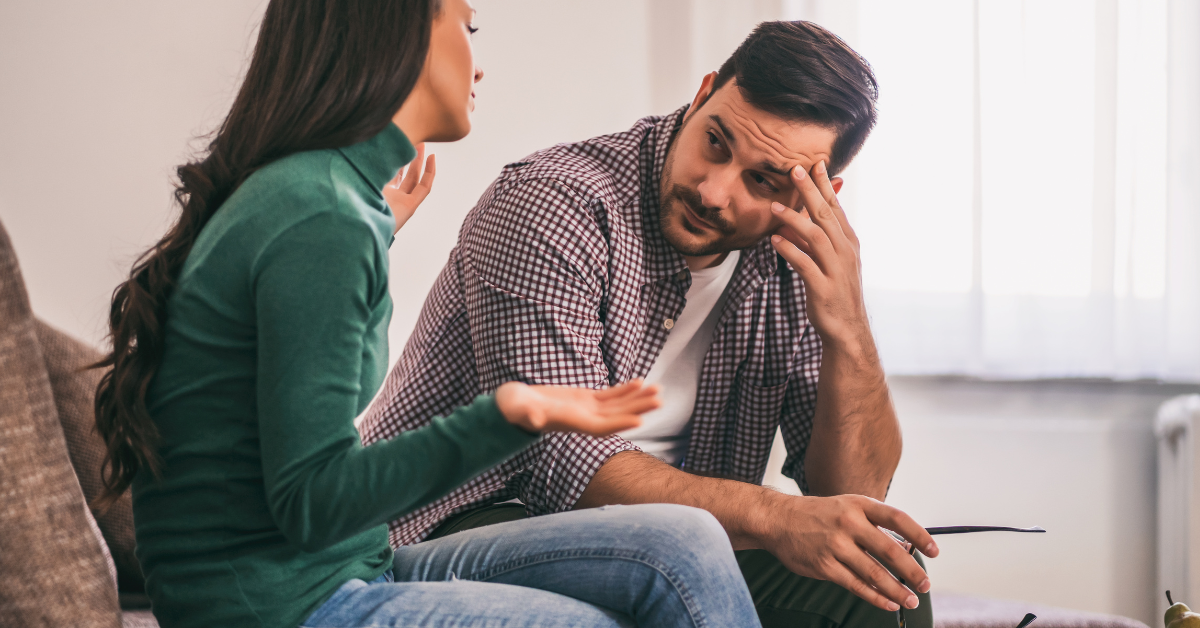 Concerned couple having an emotional conversation about relationship issues.